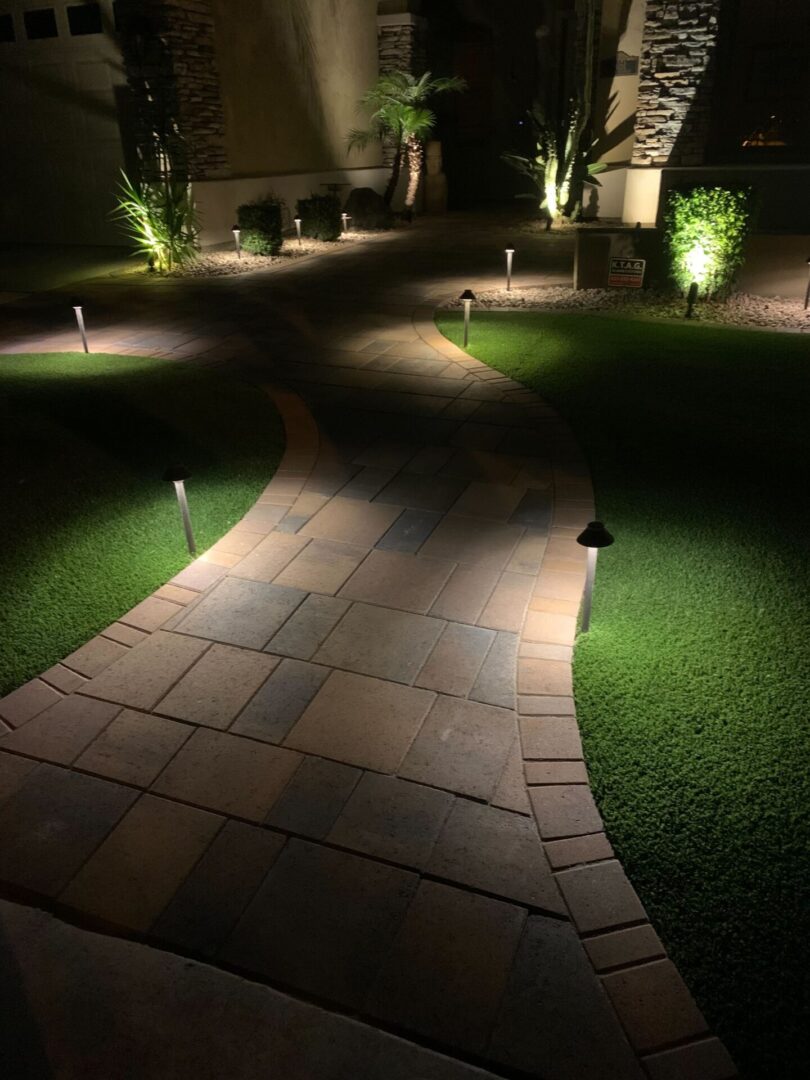 A walkway with lights on the side of it